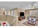 Open living room with a leather sofa and a large TV, perfect for entertaining or relaxing at 8704 New Heritage Dr, Indianapolis, IN 46239