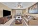 Spacious living room featuring dual sofas, a large TV, and a decorative cowhide coffee table at 8704 New Heritage Dr, Indianapolis, IN 46239