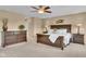 Spacious bedroom featuring a ceiling fan, lamps on side tables, and a large dresser, promoting a cozy atmosphere at 8704 New Heritage Dr, Indianapolis, IN 46239