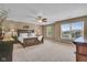 Large bedroom with decorative headboard, side tables, lamps, ceiling fan, and large windows for natural light at 8704 New Heritage Dr, Indianapolis, IN 46239