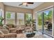 Bright sunroom with large windows, inviting armchairs, and a sliding glass door at 8704 New Heritage Dr, Indianapolis, IN 46239