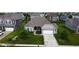Aerial view of a well-maintained home with a manicured lawn, brick facade, and an attached two-car garage at 8732 Wicklow Way, Brownsburg, IN 46112