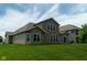 Spacious backyard featuring a lush lawn and a well-maintained house exterior with ample windows for natural light at 8732 Wicklow Way, Brownsburg, IN 46112