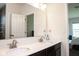 Bathroom features a double sink vanity and a door leading to the bedroom and walk in shower at 8732 Wicklow Way, Brownsburg, IN 46112