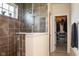Bathroom showcasing a tiled walk-in shower with glass door and linen closet at 8732 Wicklow Way, Brownsburg, IN 46112