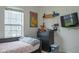 Bedroom with a large window, mounted TV, and skateboard wall art at 8732 Wicklow Way, Brownsburg, IN 46112