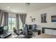 Bedroom featuring multiple gaming screens, posters, large window with natural light, and comfortable bed at 8732 Wicklow Way, Brownsburg, IN 46112