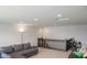 Second floor bonus room with carpeting, a gray sofa, and a dark wooden railing at 8732 Wicklow Way, Brownsburg, IN 46112