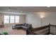 Second floor bonus room with carpeting, a gray sofa, and natural lighting from multiple windows at 8732 Wicklow Way, Brownsburg, IN 46112