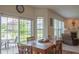 Dining area with a wood table and chairs, and sliding glass doors to the patio and backyard at 8732 Wicklow Way, Brownsburg, IN 46112