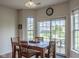 Dining area featuring a wood table, four chairs, and a sliding glass door to the outside at 8732 Wicklow Way, Brownsburg, IN 46112