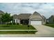 Well-maintained home with attached two car garage, brick facade, and a landscaped front yard at 8732 Wicklow Way, Brownsburg, IN 46112