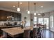 Open-concept kitchen with granite countertops, pendant lighting, and a breakfast nook with sliding door access at 8732 Wicklow Way, Brownsburg, IN 46112