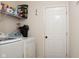 Organized laundry room with a shelf and a white front load washer and dryer set at 8732 Wicklow Way, Brownsburg, IN 46112