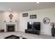Cozy living area with a fireplace, TV, and decorative accents on the wall at 8732 Wicklow Way, Brownsburg, IN 46112