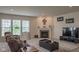 Inviting living room with a fireplace, soft carpet, comfortable furniture, and a mounted TV at 8732 Wicklow Way, Brownsburg, IN 46112