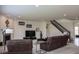Spacious living room with comfortable seating, a fireplace, staircase, and ample natural light at 8732 Wicklow Way, Brownsburg, IN 46112