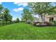 Well-maintained backyard with a lush green lawn, patio area, and scenic landscaping, ideal for outdoor activities at 9179 Brookstone Pl, Zionsville, IN 46077