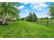 Lush, fenced backyard featuring well-kept lawn and landscaping, offering a private and serene outdoor space at 9179 Brookstone Pl, Zionsville, IN 46077