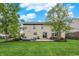 Beautiful backyard featuring a stone patio, outdoor seating, and well-maintained lawn for leisure and entertaining at 9179 Brookstone Pl, Zionsville, IN 46077
