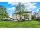 Manicured backyard with lush lawn, patio space, outdoor seating, and beautiful landscaping for relaxation and recreation at 9179 Brookstone Pl, Zionsville, IN 46077