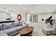 Spacious basement featuring a gray sofa, kitchenette, and piano for recreation and relaxation at 9179 Brookstone Pl, Zionsville, IN 46077
