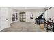 Basement recreational area with french doors, a full piano set, and space for entertainment and hobbies at 9179 Brookstone Pl, Zionsville, IN 46077
