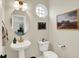 Stylish powder room with a unique vessel sink, octagon window, and gold accents at 9179 Brookstone Pl, Zionsville, IN 46077