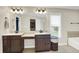 Bathroom featuring double vanity, soaking tub, and window at 9179 Brookstone Pl, Zionsville, IN 46077