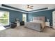 Spacious bedroom featuring a tray ceiling, large windows, and plush carpet at 9179 Brookstone Pl, Zionsville, IN 46077