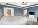 Large bedroom showcasing a tray ceiling, plush carpet, and double door closet at 9179 Brookstone Pl, Zionsville, IN 46077