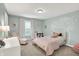 Bright bedroom featuring a large window, cozy decor, and plush carpet at 9179 Brookstone Pl, Zionsville, IN 46077