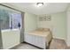 Cozy bedroom with a white bed frame, soft green walls, and natural light from the window at 9179 Brookstone Pl, Zionsville, IN 46077