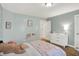 Well-lit bedroom with a large window, plush carpet, and ample wall decor at 9179 Brookstone Pl, Zionsville, IN 46077