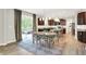Open-concept dining area with wood floors, a statement rug, and easy access to the kitchen at 9179 Brookstone Pl, Zionsville, IN 46077