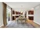 Open-concept dining area featuring a wood table, rug and sliding glass door to outdoor living space at 9179 Brookstone Pl, Zionsville, IN 46077