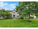 Landscaped front yard showcasing a two-story home with a stone facade and well-maintained lawn at 9179 Brookstone Pl, Zionsville, IN 46077