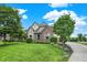 Well-manicured lawn leading to a beautifully designed two-story home with brick and stone accents at 9179 Brookstone Pl, Zionsville, IN 46077