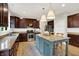 Kitchen boasts custom cabinetry, stainless appliances, granite countertops and a center island at 9179 Brookstone Pl, Zionsville, IN 46077