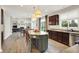 Open layout connects kitchen and living room, boasting stainless appliances and counter seating at 9179 Brookstone Pl, Zionsville, IN 46077
