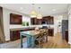 Kitchen features granite countertops, a center island with seating and wooden floors at 9179 Brookstone Pl, Zionsville, IN 46077