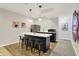 Contemporary kitchenette with bar seating, stainless steel appliances, and modern lighting at 9179 Brookstone Pl, Zionsville, IN 46077