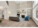 Open living room with high ceilings, large windows, fireplace, and modern decor at 9179 Brookstone Pl, Zionsville, IN 46077