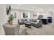 Comfortable living room with sectional couch, kitchen island, and recessed lights at 9179 Brookstone Pl, Zionsville, IN 46077