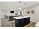 Open-concept living room with a sectional sofa, kitchen island, and recessed lighting at 9179 Brookstone Pl, Zionsville, IN 46077