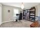 Well-lit home office featuring a large desk, comfortable chair, and shelving for books and decor at 9179 Brookstone Pl, Zionsville, IN 46077