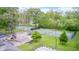 Aerial view of tennis courts, playground and lounge chairs nestled by lush trees at 9324 W Point Pl, Indianapolis, IN 46268
