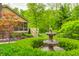 Well-manicured backyard with a fountain feature and manicured landscaping at 9324 W Point Pl, Indianapolis, IN 46268