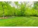 Beautiful backyard with a lush green lawn and mature trees at 9324 W Point Pl, Indianapolis, IN 46268