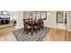 Elegant dining room featuring a dark wood table, stylish chairs, and a patterned rug at 9324 W Point Pl, Indianapolis, IN 46268